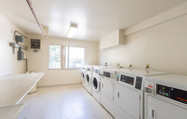 a laundry room with washes and dryers in it