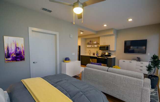 a bedroom with a bed and a couch at Link Apartments® Canvas, Atlanta, GA