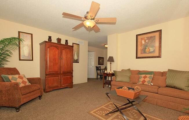 a living room filled with furniture and a lamp