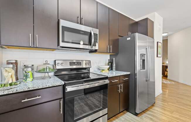 a modern kitchen with stainless steel appliances and a stainless steel refrigerator