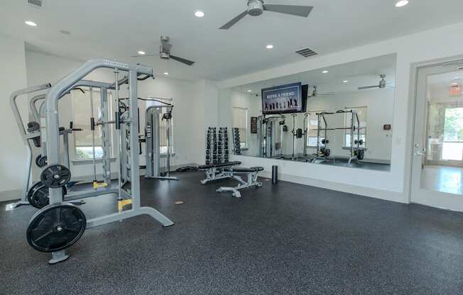 A spacious gym with a variety of equipment.