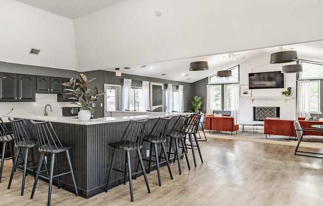 A modern kitchen with a bar area and a fireplace