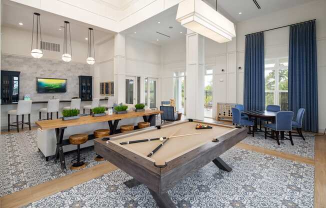 Resident clubhouse with billiard table and seating areas at The Highland in Augusta, GA