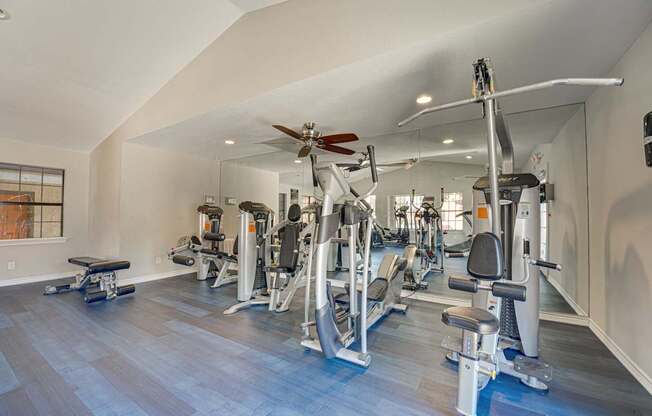 A spacious home gym with a variety of exercise equipment.