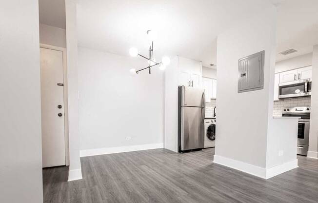 a kitchen with a stainless steel refrigerator and a stove