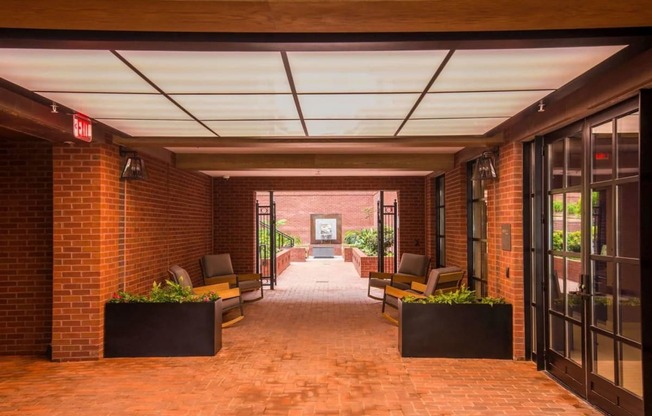 the lobby of a building with brick walls and glass doors