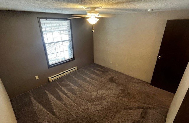 a empty room with a ceiling fan and a window