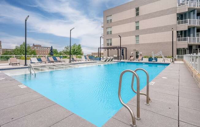a swimming pool with a building in the background