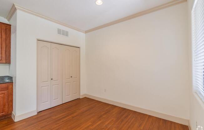 A room with a wooden floor and a white door.