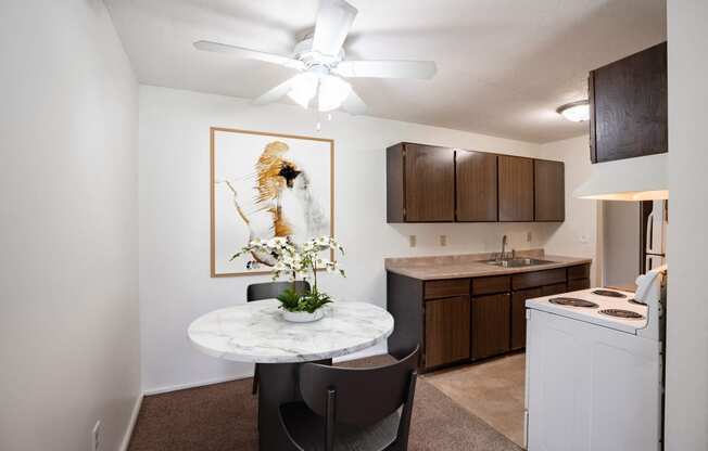 our apartments offer a kitchen and living room with a round table. Coon Rapids, MN Robinwood Apartment