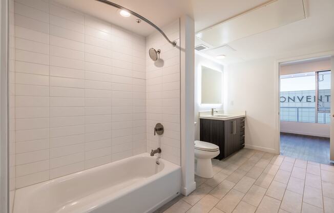 a bathroom with a tub and a toilet and a sink