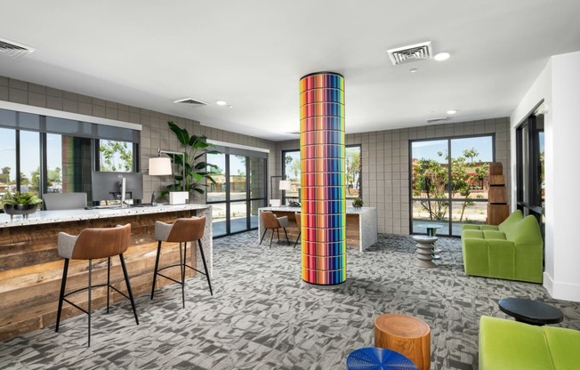 a lobby with a colorful column in the middle of a room