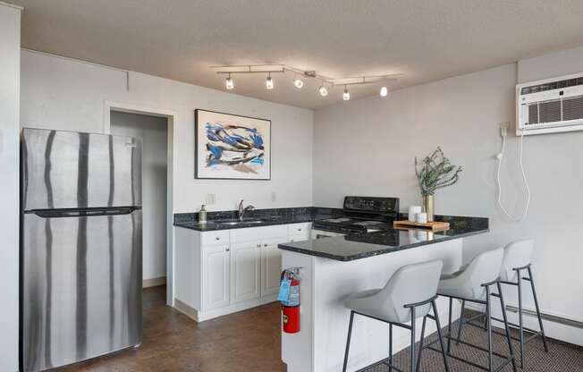 a kitchen with a counter top and a refrigerator