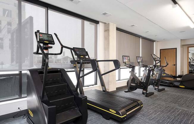 a gym with treadmills and other exercise equipment at The Bohen Apartments , Minnesota, 55408