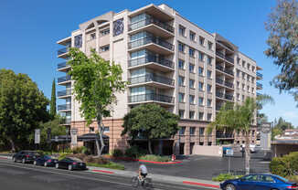 Apartments in Palo Alto, California - Tan Plaza - Exterior View of Tan Plaza Building with Trees, View of Covered Parking, Street View, and Unit Balconies