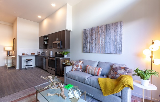 Open living area and kitchen with stainless steel appliances and modern fixtures