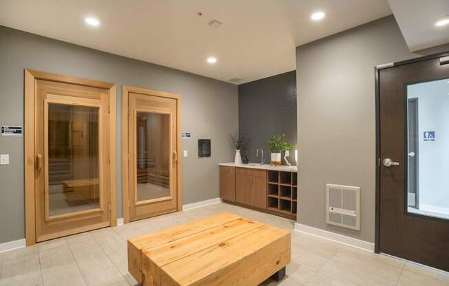 a large room with a wooden table in the center and two doors