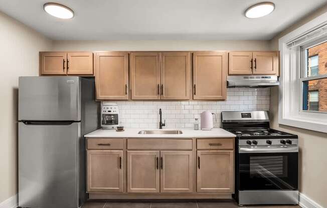 a kitchen with stainless steel appliances and wooden cabinets