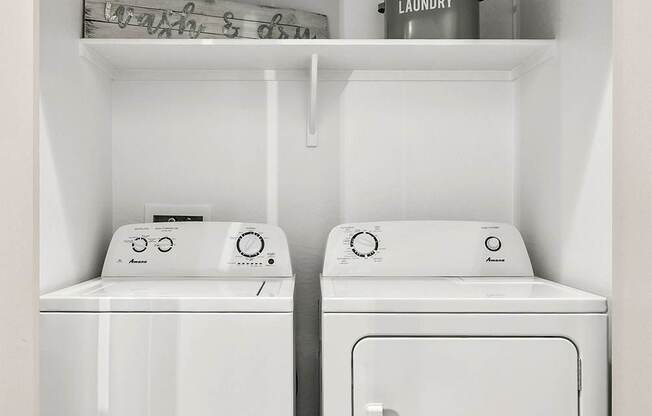 A white laundry room with a washer and dryer.
