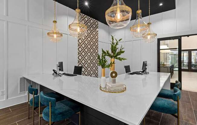 A modern kitchen with a white countertop and blue chairs.at Century Grove Park, Knightdale