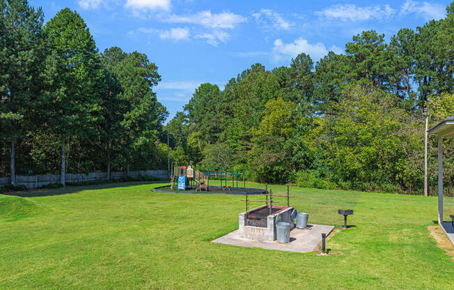 a park with a playground and a fire pit