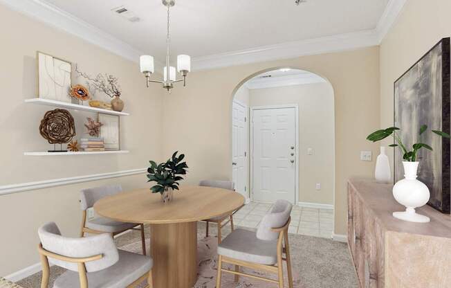 A dining room with a round table and chairs.