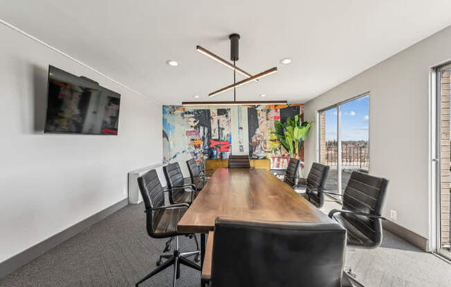 A conference room with a long table and chairs.