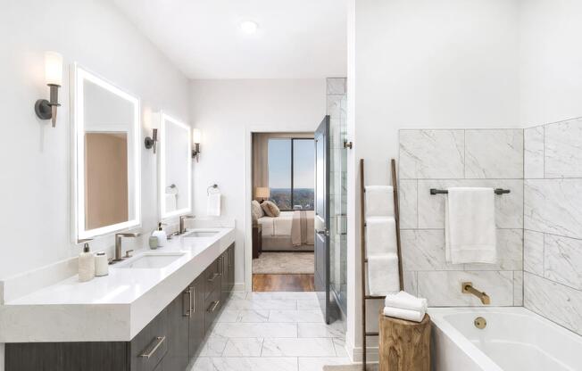 A penthouse primary bath defined by clean geometry, warm wood cabinetry, and layered stone finishes for a cohesive, modern look.
