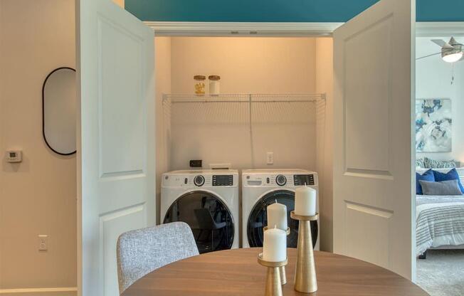 a laundry room with a table and chairs and a washing machine