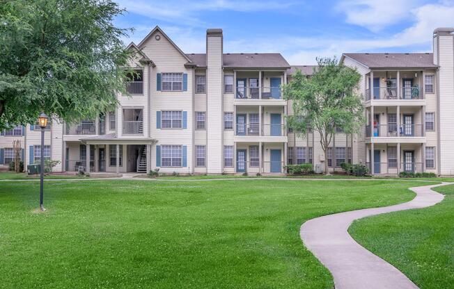 a large lawn in front of a brick building