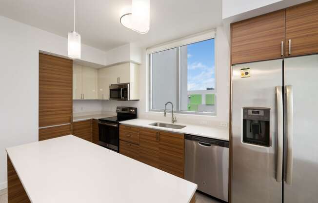 a kitchen with white countertops and wooden cabinets