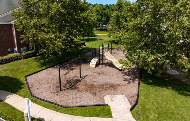 a playground with a slide and monkey bars in the middle of a grassy area