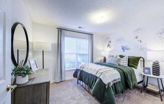 A bedroom with a bed, a dresser, and a mirror.