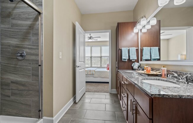 a bathroom with a shower and a sink and a mirror