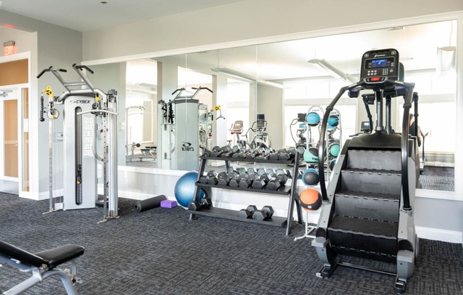 a gym with weights and other equipment in a building