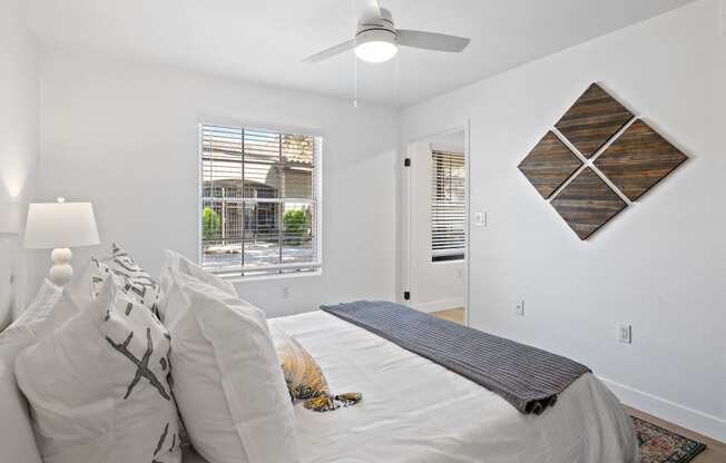 a bedroom with a large bed and a ceiling fan