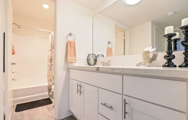 Long single vanity area with marble counter tops, bathroom on the left