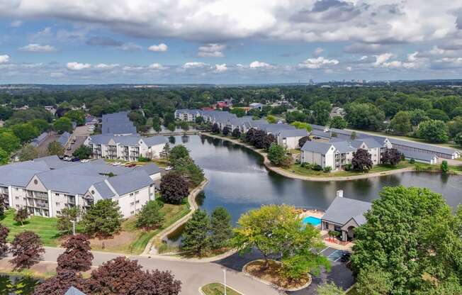 an aerial view of apartment buildings next to a lake