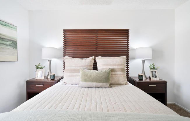 a bedroom with a bed and a pink and purple wall