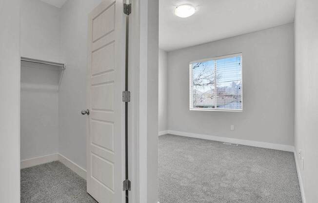 A room with a white door and a window showing a snowy landscape outside.