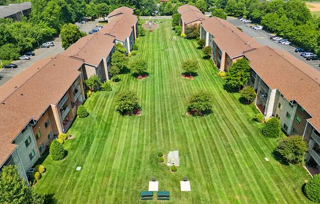 an aerial view of an apartment complex with a green lawn