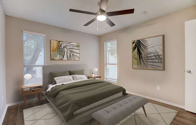 a bedroom with a bed and a ceiling fan