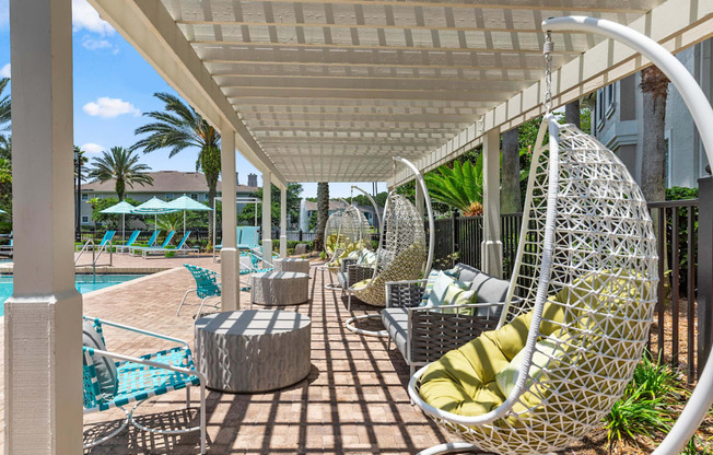 A white patio with a white canopy and a white chair.