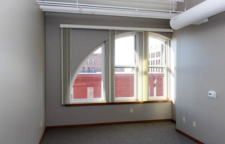 Here this historic windows overlooking Court Street add interest to a Call Terminal living room.