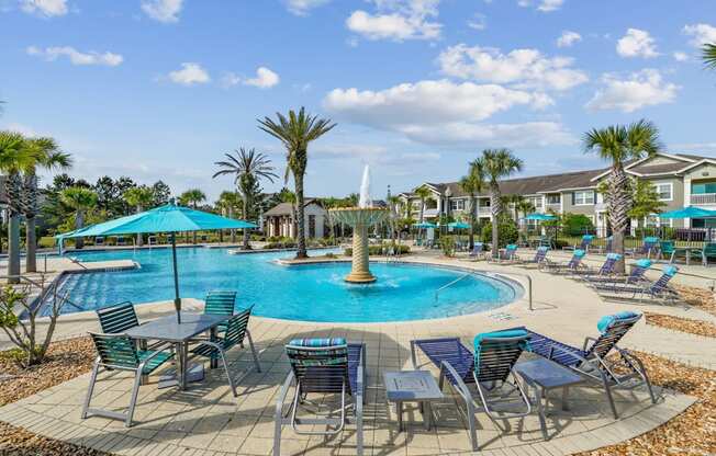 A pool with a fountain in the middle of it.