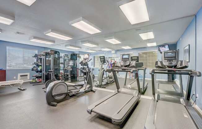 a gym with treadmills and other exercise equipment