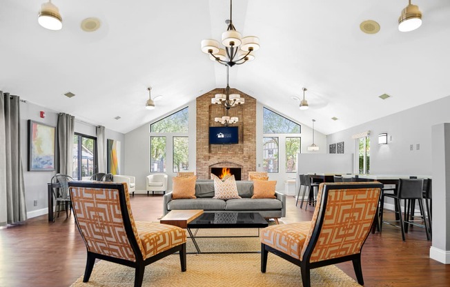 a living room with a couch and chairs and a fireplace