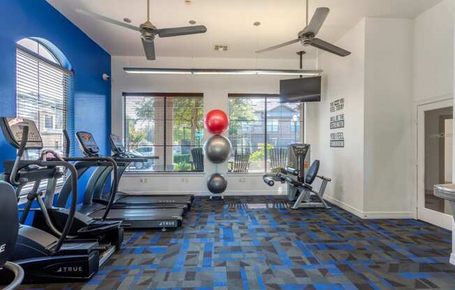 the gym at the district at highland village apartments