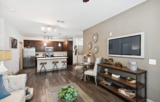 Living Room with TV and Kitchen in the Background at The Loree, Jacksonville, FL, 32256