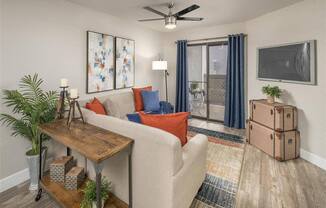 a living room filled with furniture and a ceiling fan